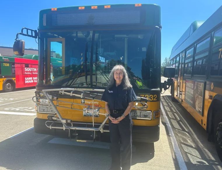 Image of Tammy standing in front of her bus after winning the Metroadeo