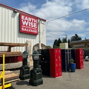 Picture of Earthwise Architectural Salvage sign with salvaged construction materials in the foreground