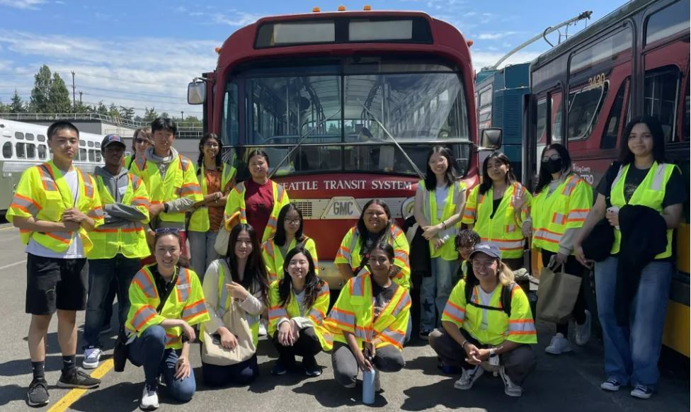 Photo of youth internships participants in front of historic Seattle Transit system bus