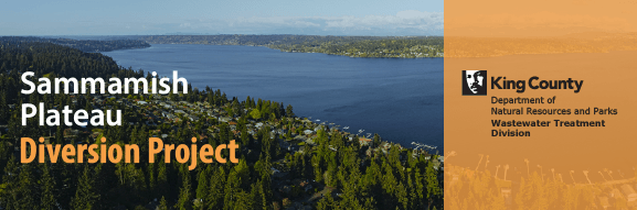 An aerial image of Lake Sammamish, boat docks lining the lake, and it’s evergreen tree-covered shoreline.