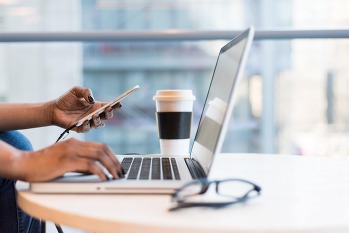 hands with phone and computer