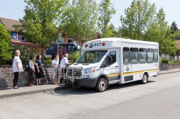 people lined up to board the SVT short bus