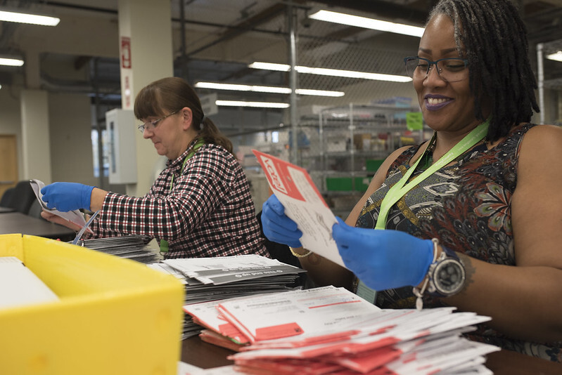 Ballots are counted by workers at King County Elections