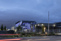  A purple lit industrial facility against a dark moody sky.  