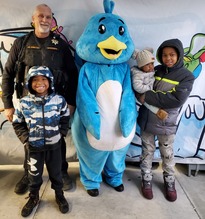 Emery with Deputy and kids at shop with a cop 