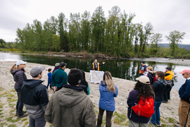 A group of people tour the floodplain restoration project along the Snoqualmie River.