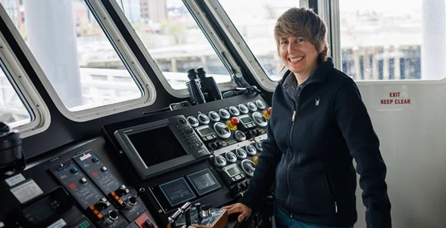 Photo of new Captain Shane Rich at front of Water Taxi vessel