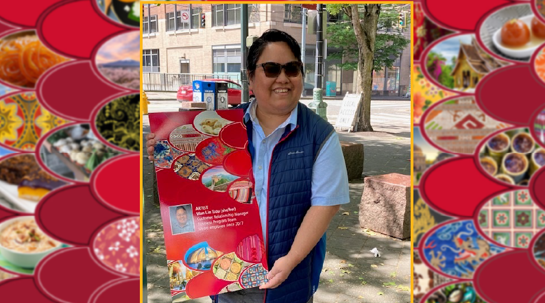 Picture of  Wan-Lin Tsou with a poster of her art that was installed at a Metro stop