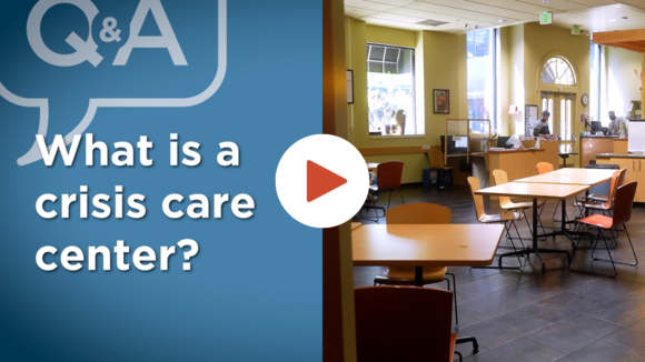 A graphic with a video play button and the text what is a Crisis Care Center?