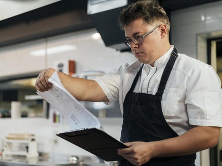 Restaurant manager reading a document