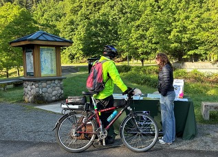 Project team member speaking with trail user during Bike Everywhere Day. 
