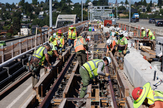 Crew members work on the I-90 light rail segment