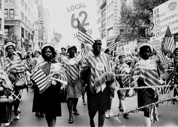 Black and white photo of workers marching