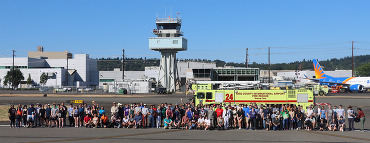 About 100 people pose on Runway 14R/32L at King County International Airport-Boeing Field