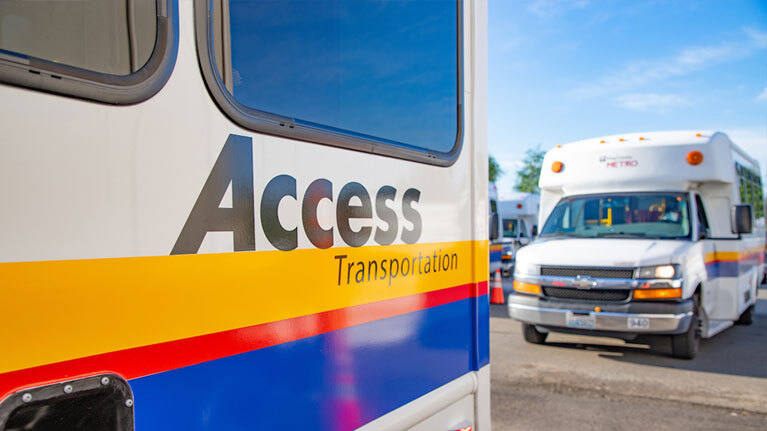 A photo of two Access vans, with one in the foreground and one in the background