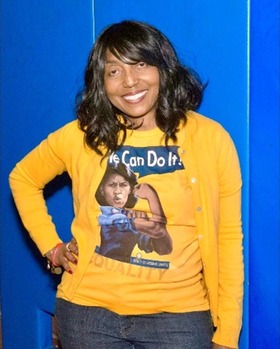 Photo of Leslie smiling and posing in yellow outfit