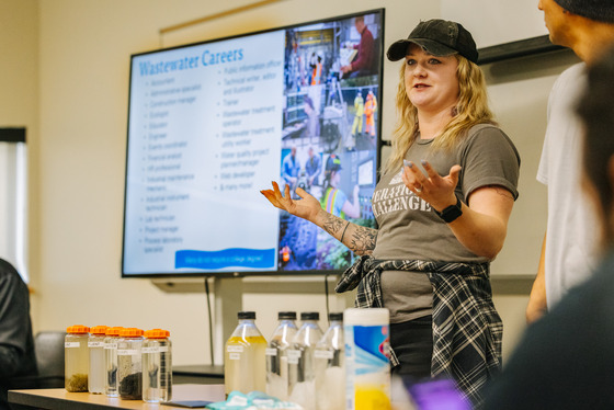 A presenter in front of a screen talks about a career in wastewater