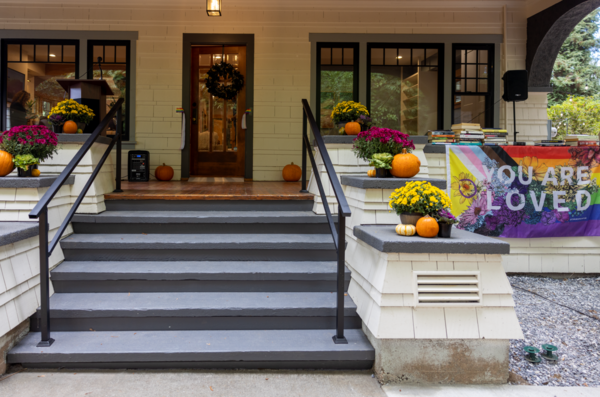 Stairs leading up to the porch and front door of a house.