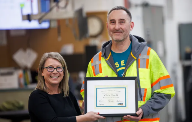 Image of GM Michelle Alison presenting award to Chris Blandi