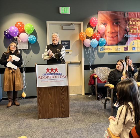 Councilmember Balducci behind a podium at National Adoption Day event at the MRJC