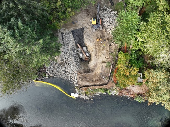 Aerial photo of a buried revetment being dug and installed during construction.