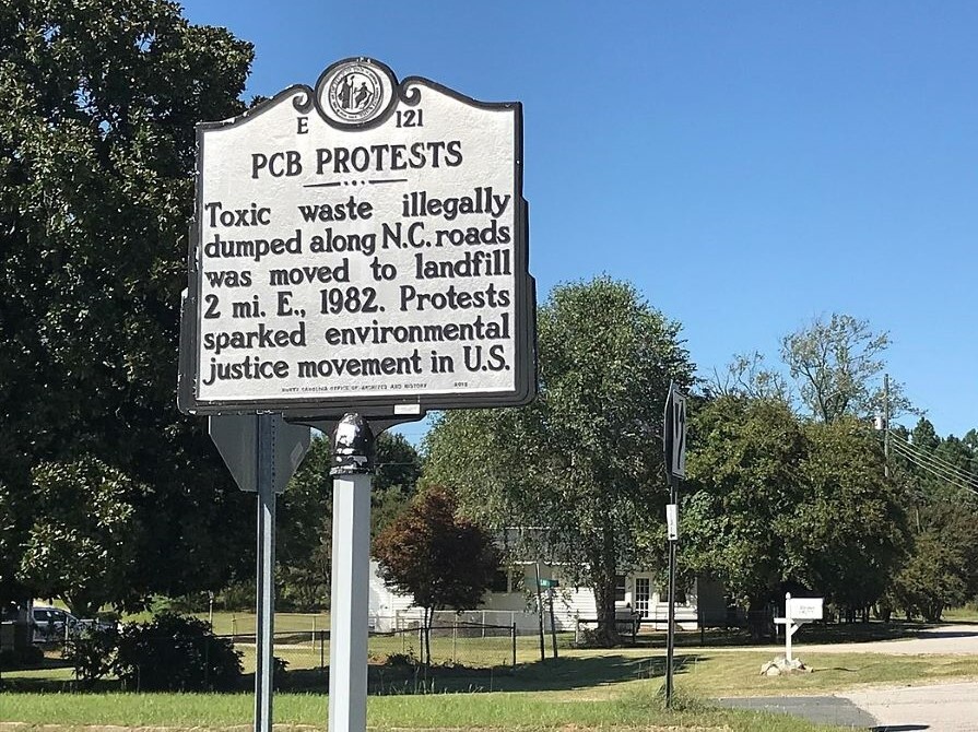 A sign on the side of a road in North Carolina showcases Black activists' role in founding the environmental justice movement