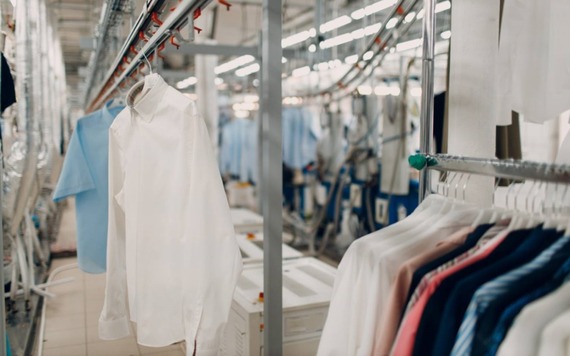 Clothes hang on racks in a dry cleaning set-up