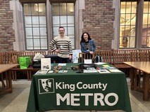 Two people standing at a Metro table