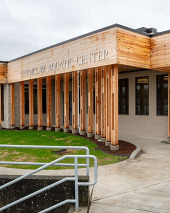 a photo of a building with a new wood facade and a sign that reads "Enumclaw aquatic center"