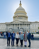 Six people stand in front of the U.S. Capitol Building in Washington, D.C., advocating for clean water funding.