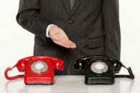 Red and Black Phone and Male Pointing to Black Phone 