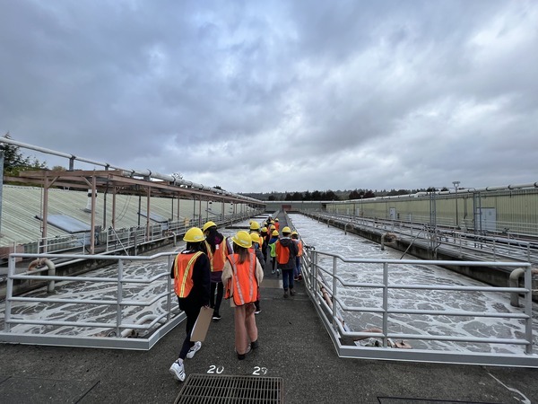 Community members exploring aeration tanks during the treatment plant tour. 
