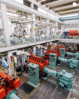 Industrial facility with large machines and pipes.