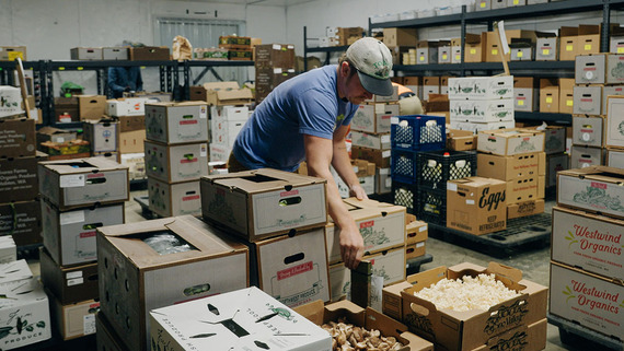 man surrounded by food boxes