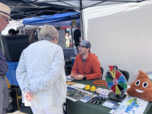 West Point staff speaking with families at the Magnolia Farmers Market earlier this summer.