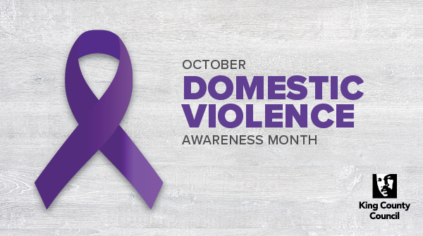 A  Domestic Violence Awareness Month graphic with a purple ribbon on a gray background