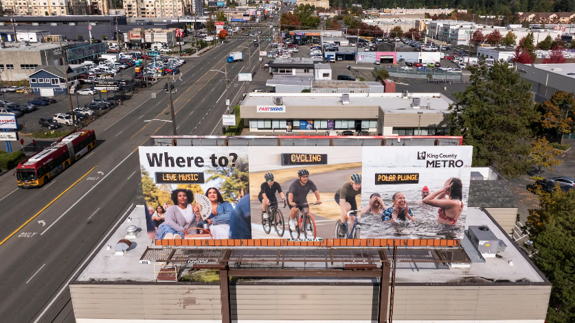 billboard of Where to? campaign ad above a building and busy street