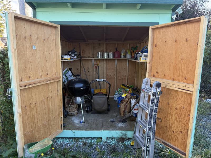 Open garden shed containing hazardous materials