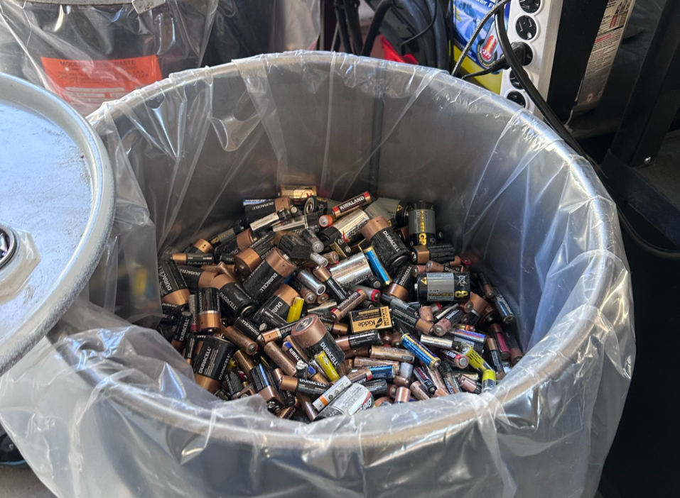 Garbage bin filled with several types of batteries