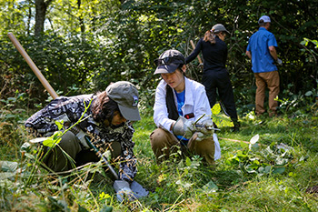 Photo of two people with a shovel