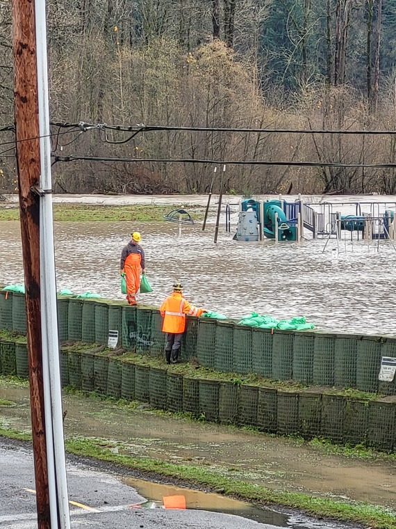 crews reinforce the river bank against flood waters. 