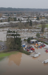 Aerial view of flooded neighborhoods and staging area as King County crews continue flood response during a historic storm.