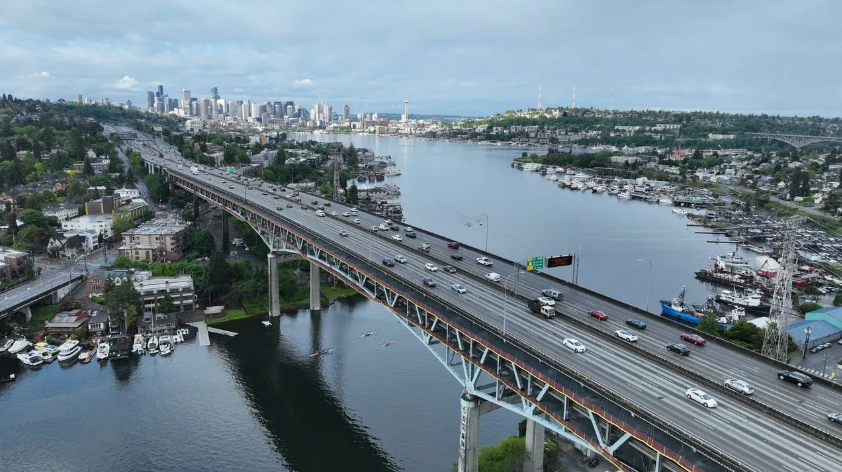 Aerial view of the Ship Canal Bridge and I 5 with the Seattle city skyline behind it  