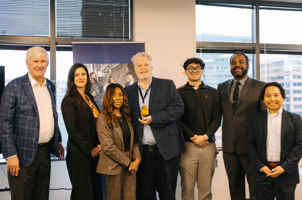 John Stanton and Terry Blake and staff from the Department of Executive Services smile with the Year Up Award.
