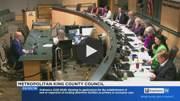 A screenshot of a video of King County Councilmembers sitting on the dais during a Council meeting