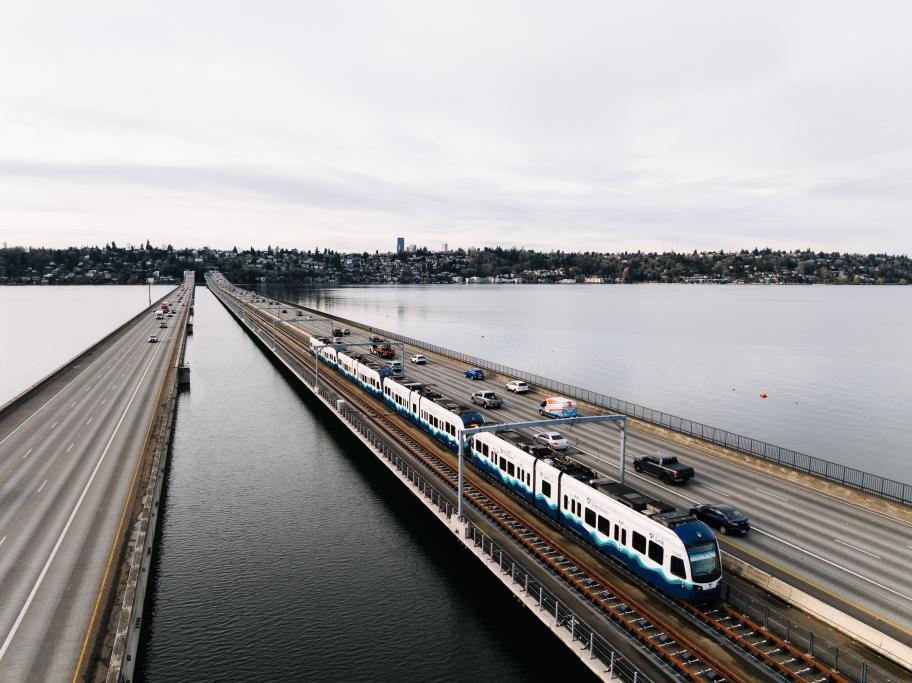 A light rail train crosses the I-90 bridge