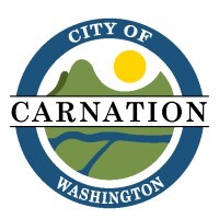 Circular logo with green cartoon mountain, blue river, and yellow sun and the text "City of Carnation Washington."