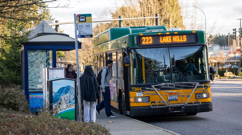 image of bus route 223 Lake Hills at a bus stop with riders boarding the bus
