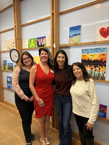 Councilmember Fain with three women standing in front of a wall with several paintings