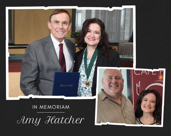 In memoriam Amy Hatcher, with a portrait of her and a man holding a blue folder, and a smaller photo of her with another man in front of a cafe sign.